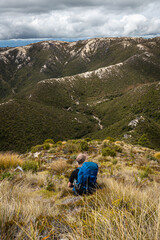 Man hiking in the mountains of Kahurangi National Park in New Zealand