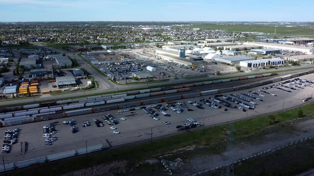 Drone shot of long trains in Calgary's industrial area.