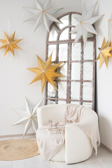 Cozy corner featuring elegant stars and soft textiles in a bright room with a vintage window and chic accents