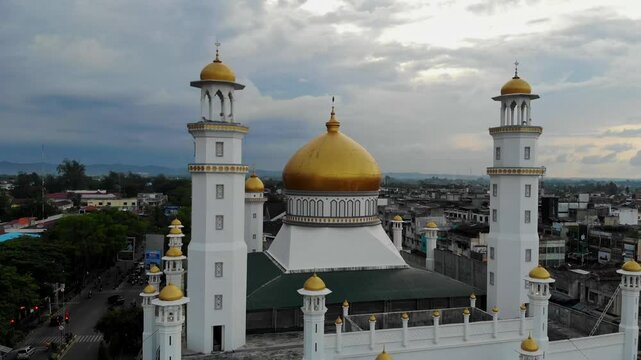 Aerial video of the beauty of the golden dome of the Grand Mosque in Langsa City, Aceh
