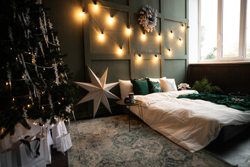 Cozy winter retreat with a beautifully decorated bed and Christmas tree in a warmly lit bedroom setting