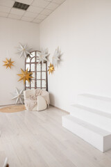 Bright and airy interior showcasing decorative stars in a minimalist space, perfect for cozy gatherings and festive occasions