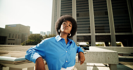Portrait, fashion and black woman in city, confidence and travel with buildings, urban town or...