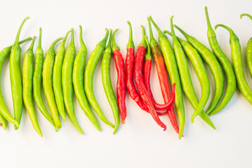 Green and red chilies arranged in line,vibrant, fresh produce.
