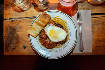 Overhead view looking down on spaghetti meatballs and egg