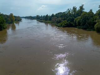 Mudflow of water in the Oder River of brown color. Poland. View from above. Background.