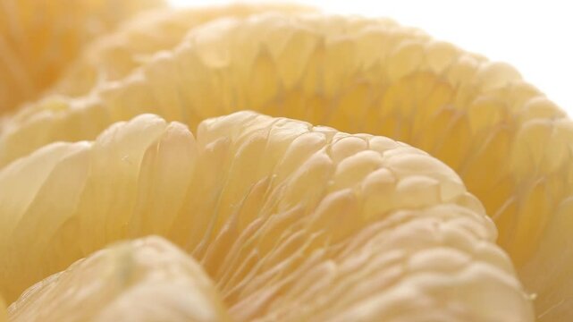 Close-up of yellow pomelo pulp texture rotating