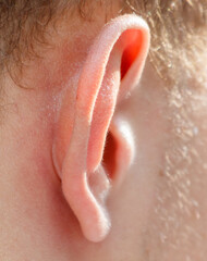 Fototapeta premium A close up of a person's ear with a red mark on it