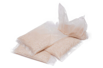 Obraz premium A Plastic Bags of White Long Grain Rice - Isolated on White Background. Small Transparent Packages with Dry Rice - Isolation
