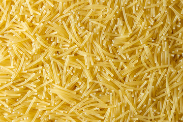 Uncooked Filini Pasta: A Culinary Canvas of Noodles, Creating a Lively and Textured Background for Gourmet Cooking. Dry Pasta. Raw Macaroni - Top View, Flat Lay