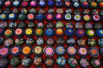 Street market in Thailand. Beautiful handmade fragrant soap in the form of traditional Asian flowers in stylized boxes for sell as souvenirs in the oriental bazaar.