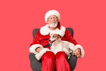 Santa Claus with cute Jack Russell Terrier dog on red background