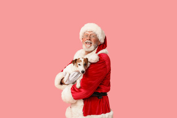 Fototapeta premium Santa Claus with cute Jack Russell Terrier dog on pink background