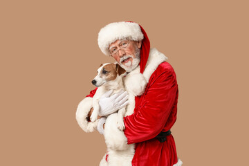 Santa Claus with cute Jack Russell Terrier dog on brown background
