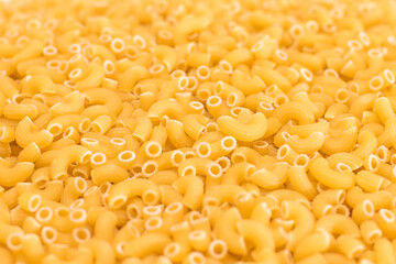 Uncooked Chifferi Rigati Pasta Background. Fat and Unhealthy Food. Classic Dry Macaroni Texture. Italian Culture and Cuisine. Raw Pasta