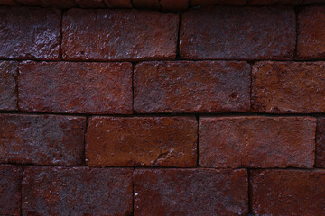 Old and aged red brick wall texture background with vignetting.