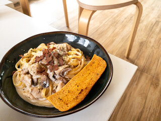 beef fetuccini carbonara with mushroom sauce on wooden table