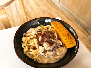 beef fetuccini carbonara with mushroom sauce on wooden table
