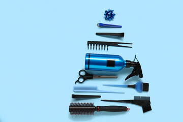 Beautiful Christmas tree made of hairdresser's tools and decorations on color background