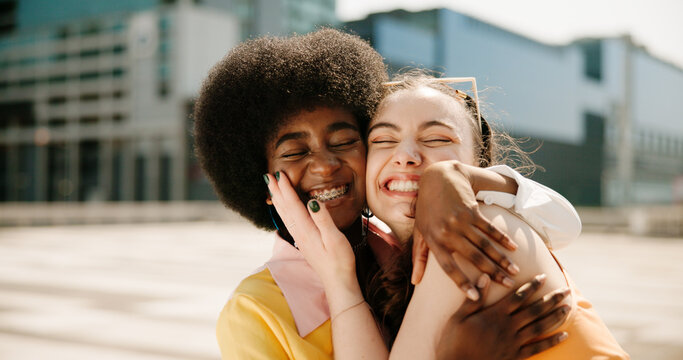 Friends, hug and fashion with people in city for youth, culture and identity. Support, community and cool with gen z friends in urban downtown for vacation, trends or streetwear style together