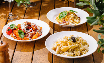 Variety of italian pasta on rustic wooden table