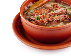 Steaming hot bowl of soup with meat and vegetables