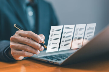 task audit in a list of documents, tick the checkmark in the survey item on a laptop. checklist concept, tick mark evaluation in options check form online, process order, detail business verify task 