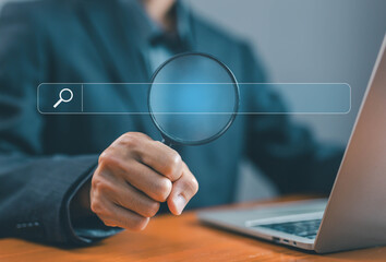 businessman using a laptop show a search bar. concept of keyword search engines, web browser...