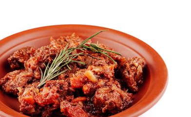 Delicious beef stew with vegetables simmering on plate