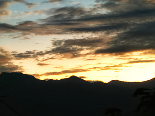 Sunset from the top of the black hills or mountains with shiny clouds in the sky