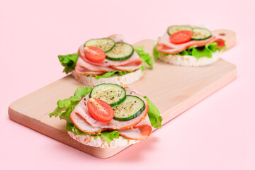 Light Breakfast. Quick and Healthy Sandwiches. Rice Cakes with Ham, Tomato, Fresh Cucumber and Green Salad on Wooden Cutting Board