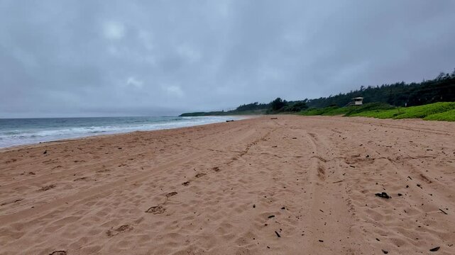 Red sand beach at Ke ala hele makalae path near Kaiakea Point in Kauai Hawaii. Morning Sunrise view by the beach in Kauai Hawaii. Beautiful cloudscape over the sea, view from a Kauai Beach