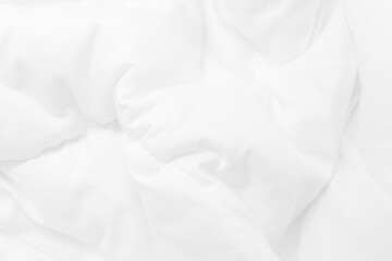 Close up top view of white bedding sheet and wrinkle messy blanket in bedroom after wake up in the morning.