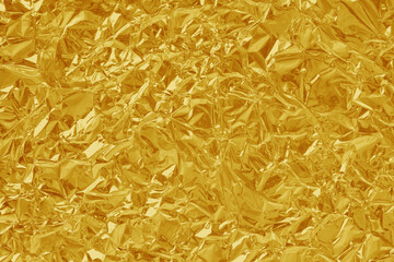 Obraz premium Gold foil leaf shiny texture, abstract yellow wrapping paper for background and design art work.