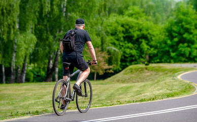 Cyclist ride on the bike path in the city Park

