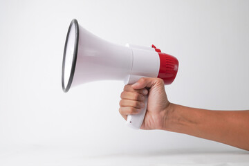 Close up photo of A man hand gripping white megaphone or loudspeaker for announcements or warning signals