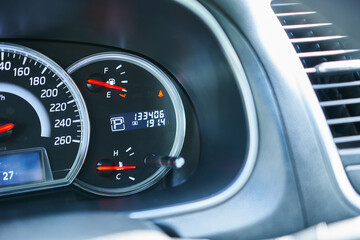 Close-up of the fuel level gauge in a modern car, note the shallow depth of field.