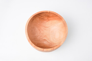 Close-up photo of Wooden bowl isolated on white background. High angle, Flat Lay Setup.