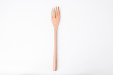 Close-up photo of wooden fork isolated on white background. High angle, Flat Lay Setup.
