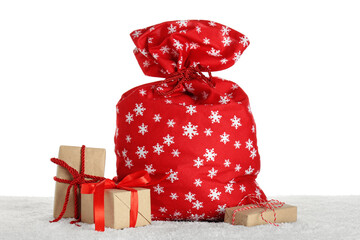 Santa bag with Christmas gift boxes on white background