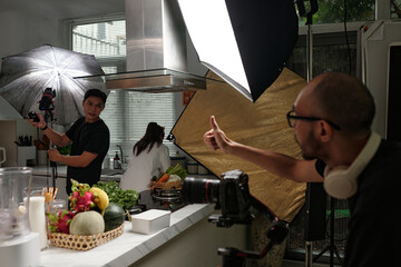 Operator showing thumb-up to his colleague while they setting cameras before shooting
