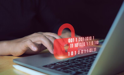 Cybersecurity and safety concept. A padlock is unlocked or hacked on laptop computer keyboard....