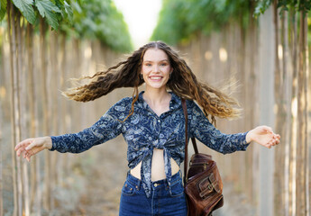 A Joyful Woman Who is Enjoying the Beauty of Nature While in a Picturesque Vineyard