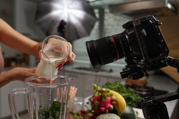 Close-up of cameraman shooting food content in studio