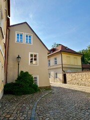 This photo captures the architectural charm and landscape of Prague’s medieval cityscape bathed in the warm glow of a summer sunset, highlighting its timeless beauty.