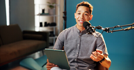 Tablet, man and podcast presenter with microphone for live streaming, talk show and online discussion. Male person, content creator and conversation as radio host in studio social media engagement
