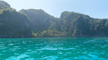 Fototapeta premium Mountains with morning light and beautiful clear green sea