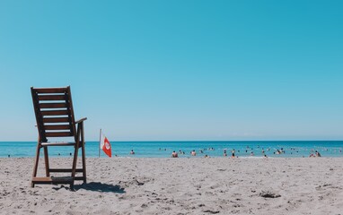 A lifeguard sitting in a high chair by the beach, watching over swimmers in the ocean, with a rescue board and red flag nearby