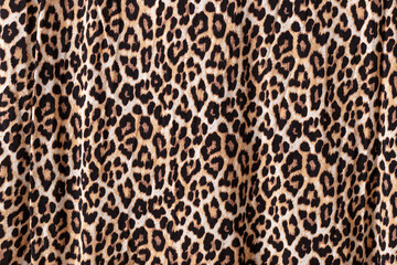 Abstract leopard texture background. Knitwear fabric with fashionable print.