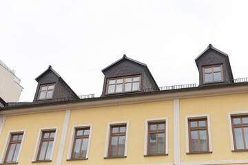 There is a bright yellow building that features numerous windows throughout its exterior, giving it a lively appearance and charm